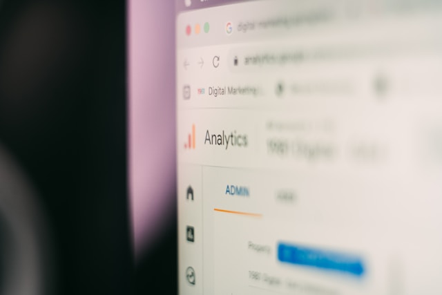 a close up of a computer monitor with blurry background showing google analytics