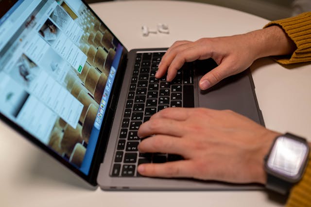 Person typing in collaboration tool on laptop