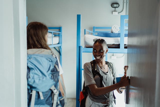 two girls entering their shared hostel room