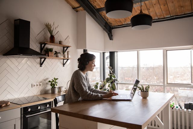 Woman typing assignment on laptop for her distance learning studies