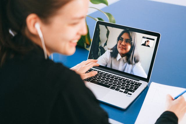 Woman using laptop to attend a distance learning class