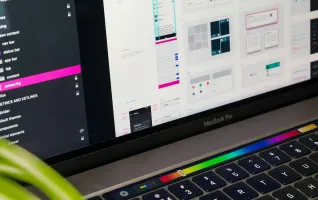 macbook pro screen displaying someone working on UX design