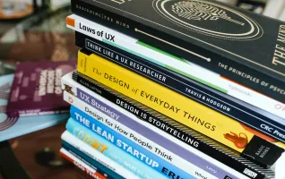 Stack of books about UX design