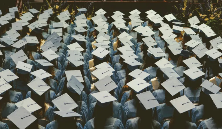 Master's degree graduates wear graduation gowns and caps during ceremony